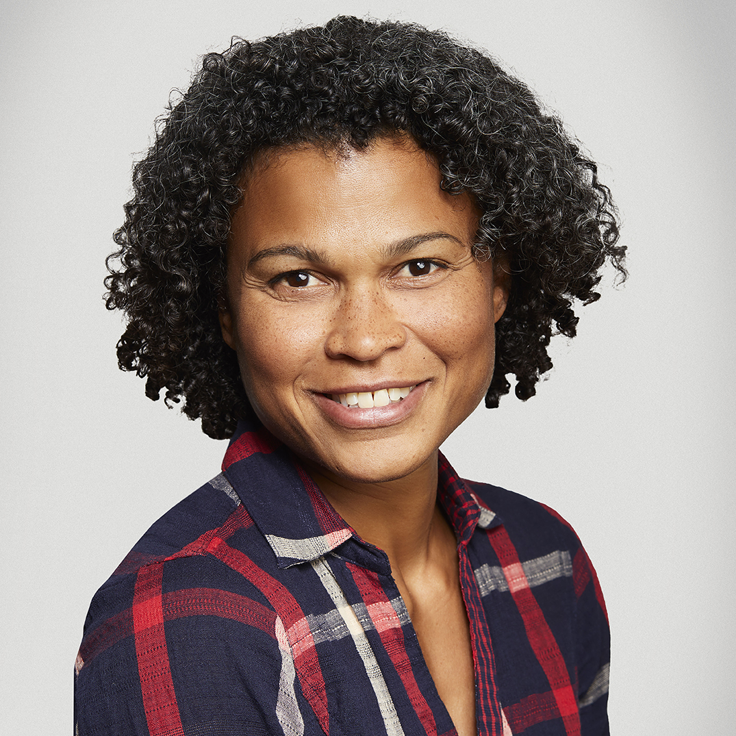 Headshot of a woman in a plaid shirt